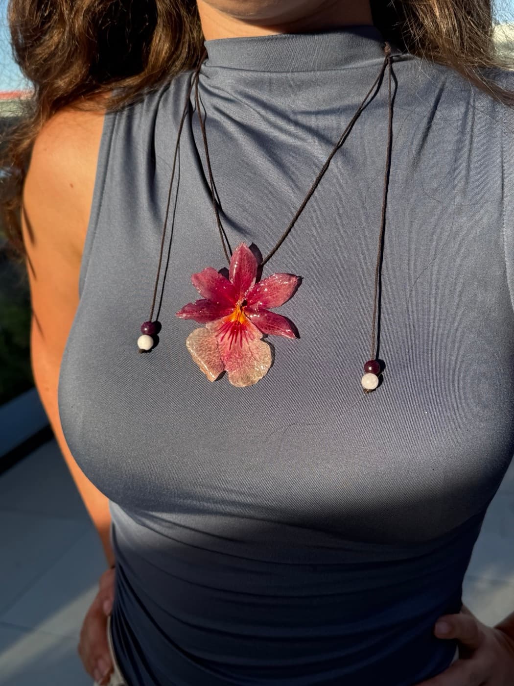 Colgante de orquídea preservada en tono rosa granate, creado en un taller de Bruma